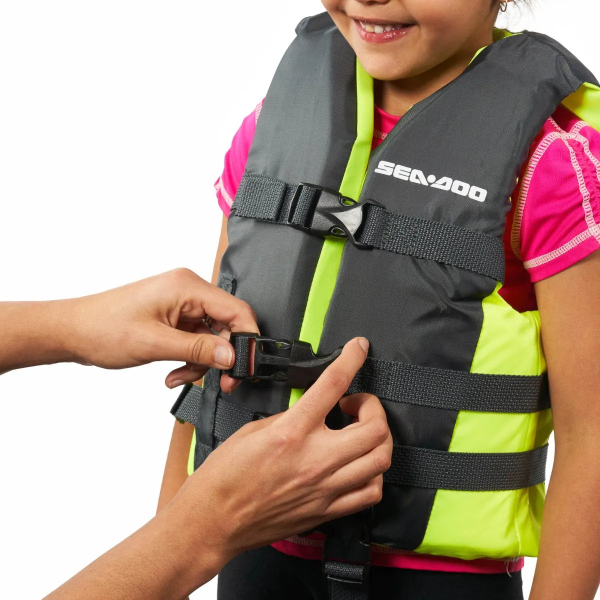 Sea-Doo Kids' Sandsea PFD life jacket, gray with neon yellow accents, being buckled.