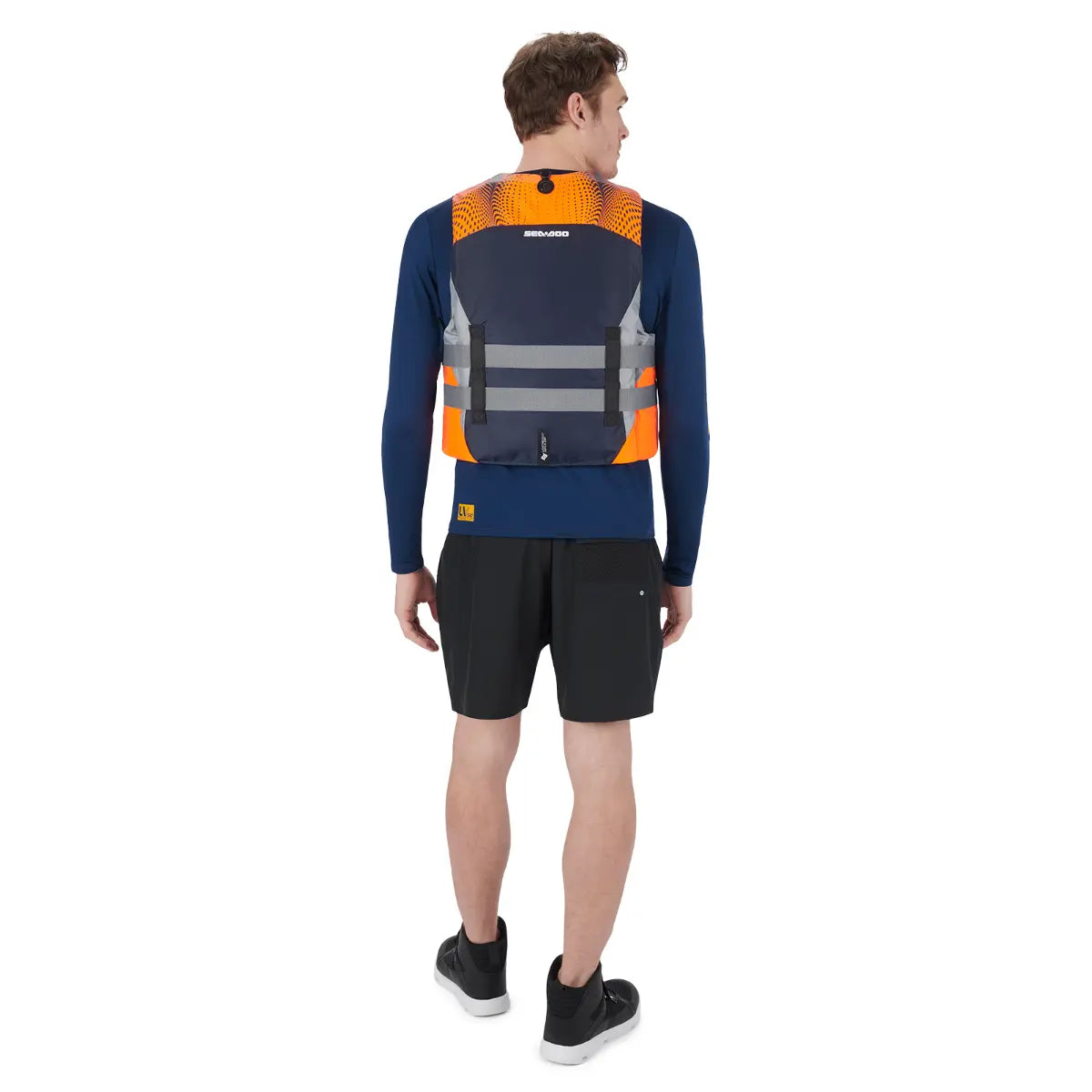 Sea-Doo Motion Life Jacket Orange PFD with navy panels and gray straps worn by a model