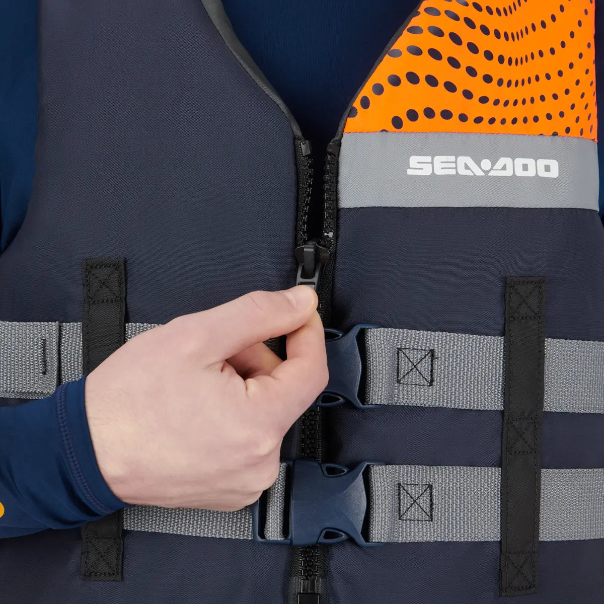 Sea-Doo Motion life jacket in orange and navy with gray straps and front zipper