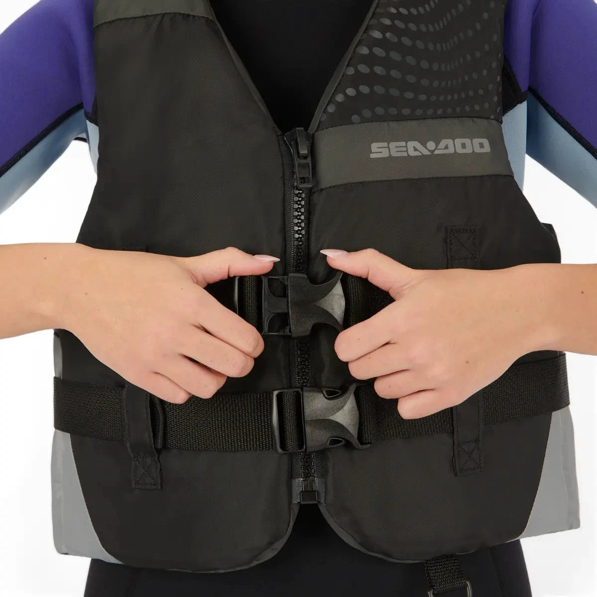 Sea-Doo Motion Life Jacket, black PFD with gray panels; front zipper and adjustable buckles, Sea-Doo logo on chest.