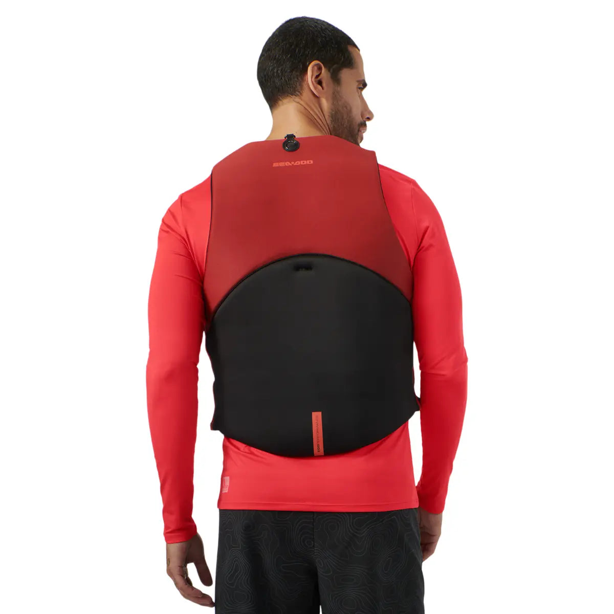 Sea-Doo Freedom PFD Lava Red life jacket worn by man; BRP branding, red upper panel and black back panel.