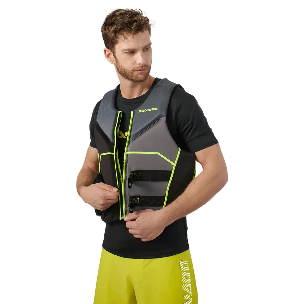 Sea-Doo Freedom PFD Black life jacket with gray panels and neon-yellow trim worn by a man