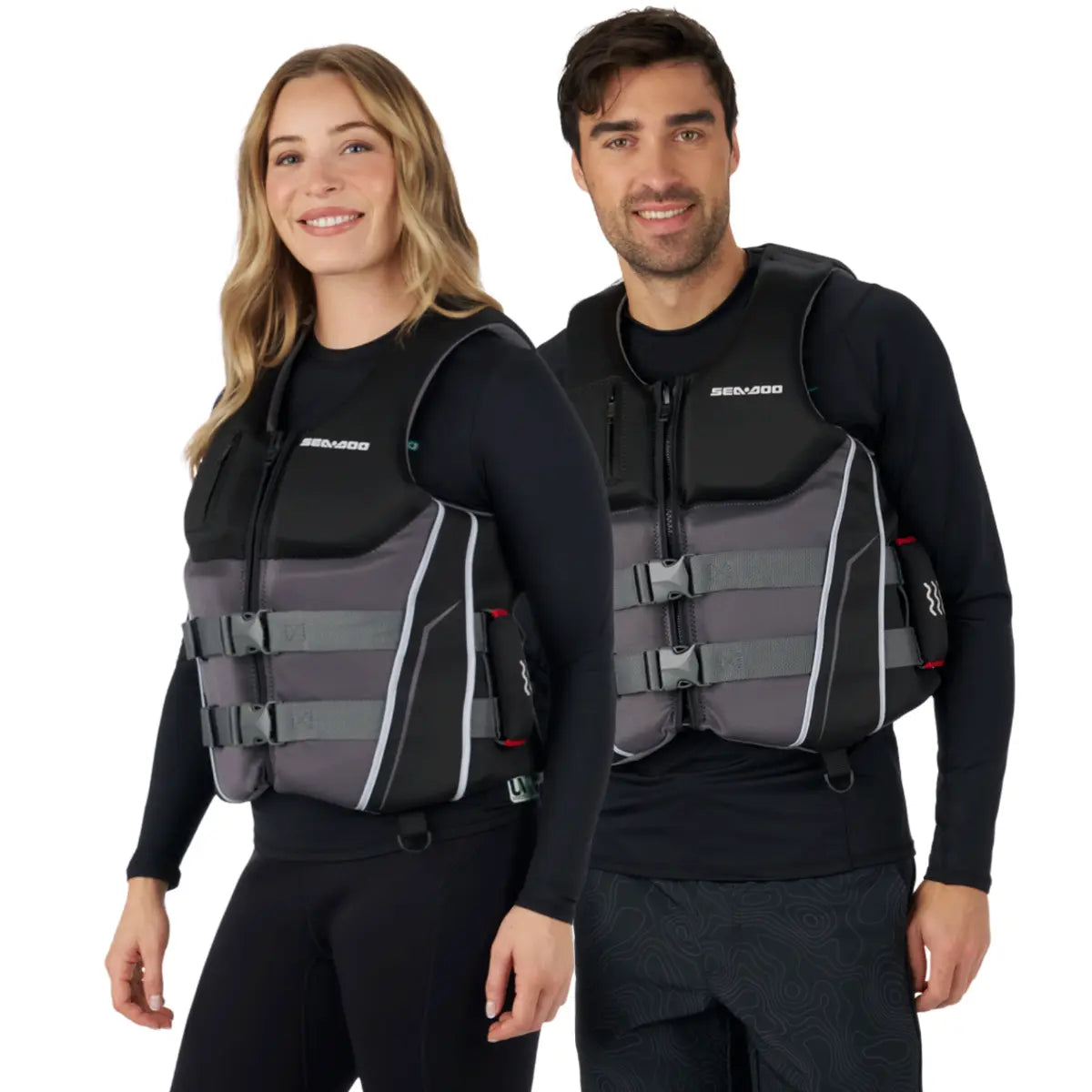 Sea-Doo Wave Grip PFD Life Jacket, unisex, black with gray panels, front zipper and buckled straps; two models wearing.