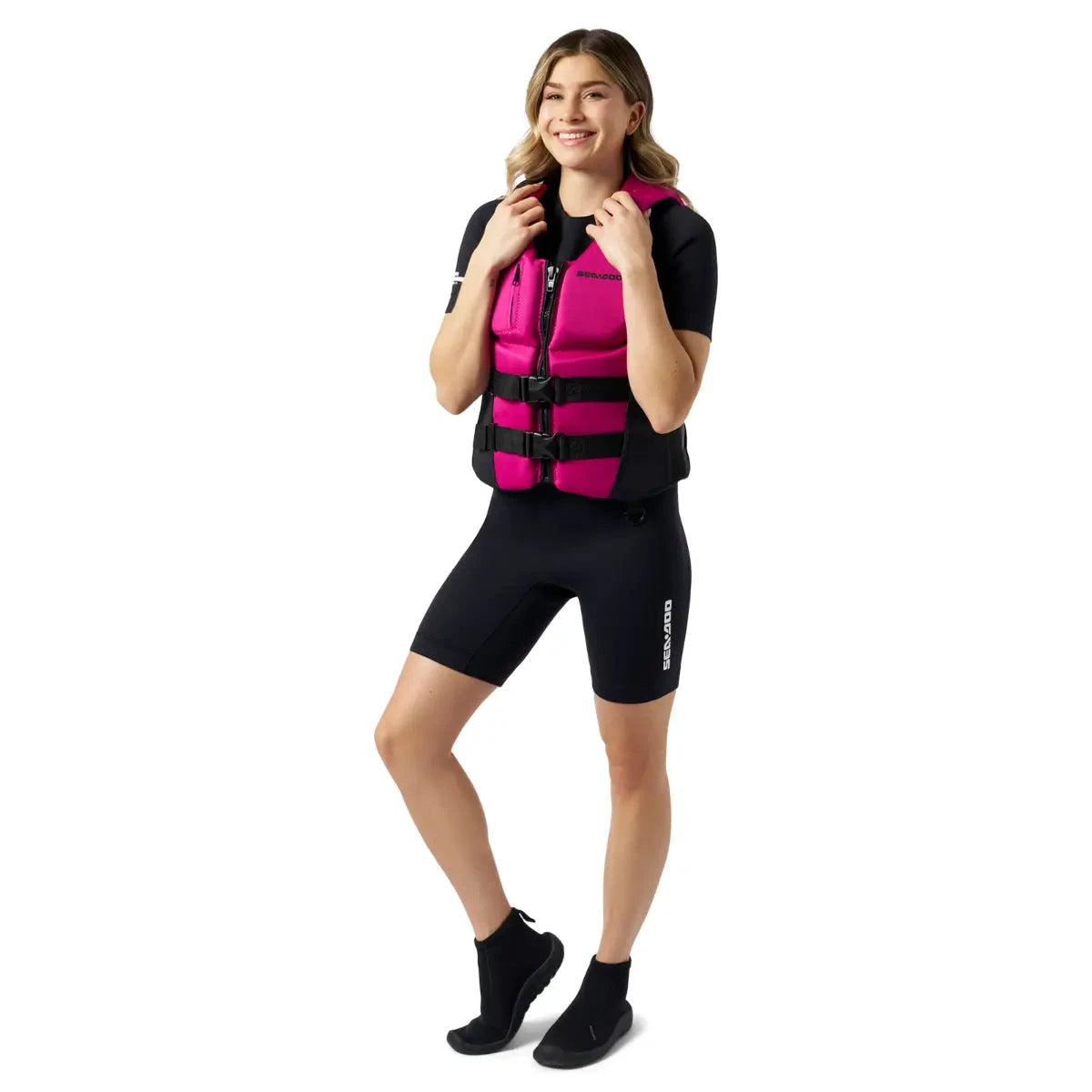Sea-Doo Wave Life Jacket/PFD in pink worn by a model in a black wetsuit