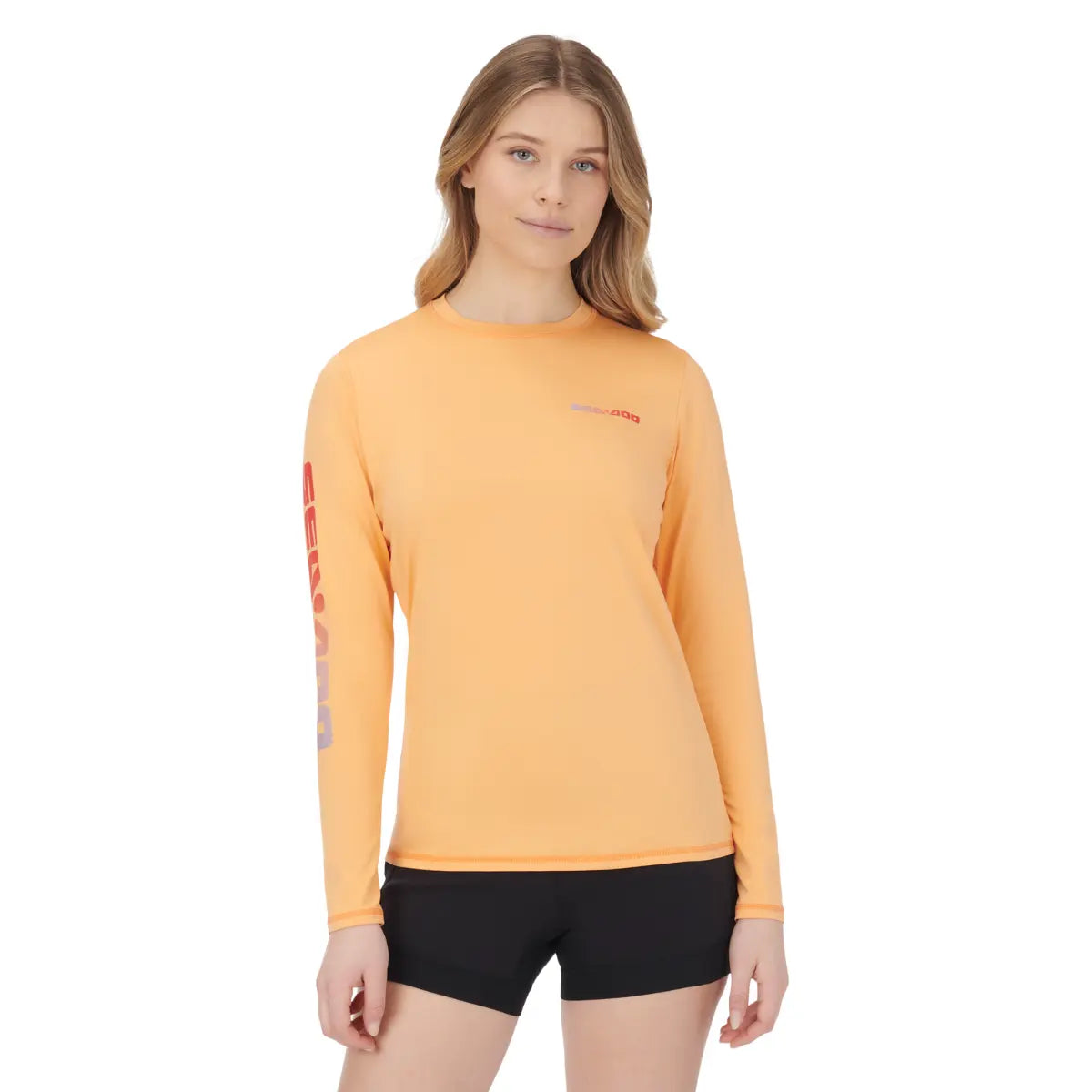 Sea-Doo women's long-sleeve rashguard coral orange; BRP riding gear with Sea-Doo logo on sleeve