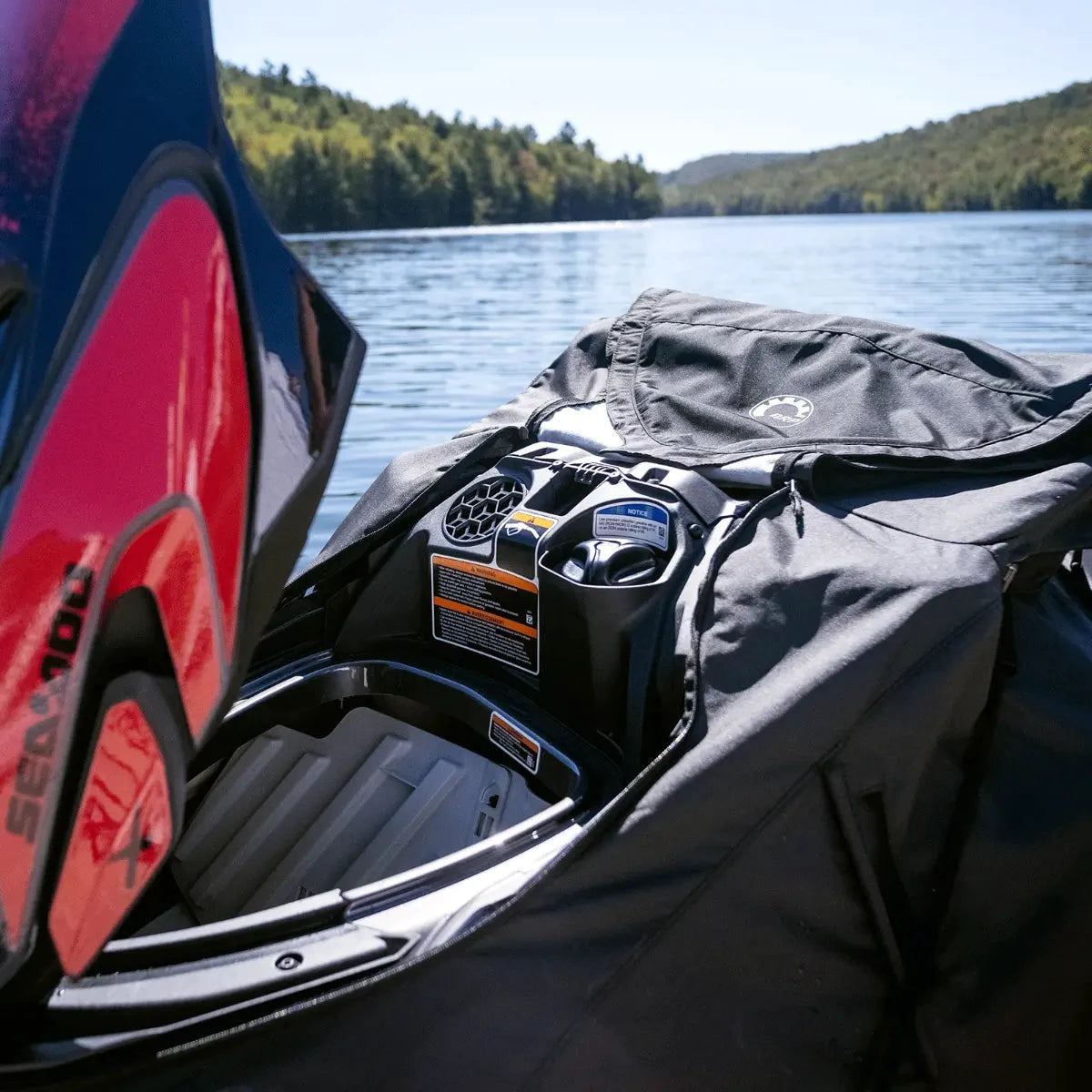 Sea-Doo PWC Cover by BRP for GTI/GTR 2020–2026 on a black jet ski cockpit beside a lake.