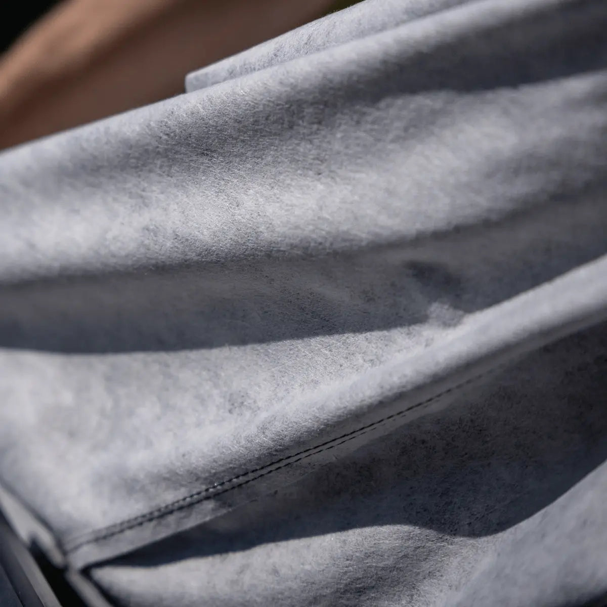 Sea-Doo PWC cover fabric close-up in gray suede-like material.