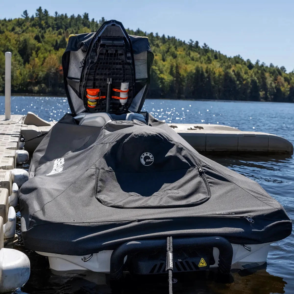 PWC cover by Sea-Doo (BRP) in black for GTX Wake Pro & RXT, BRP logo visible on cover at dock.