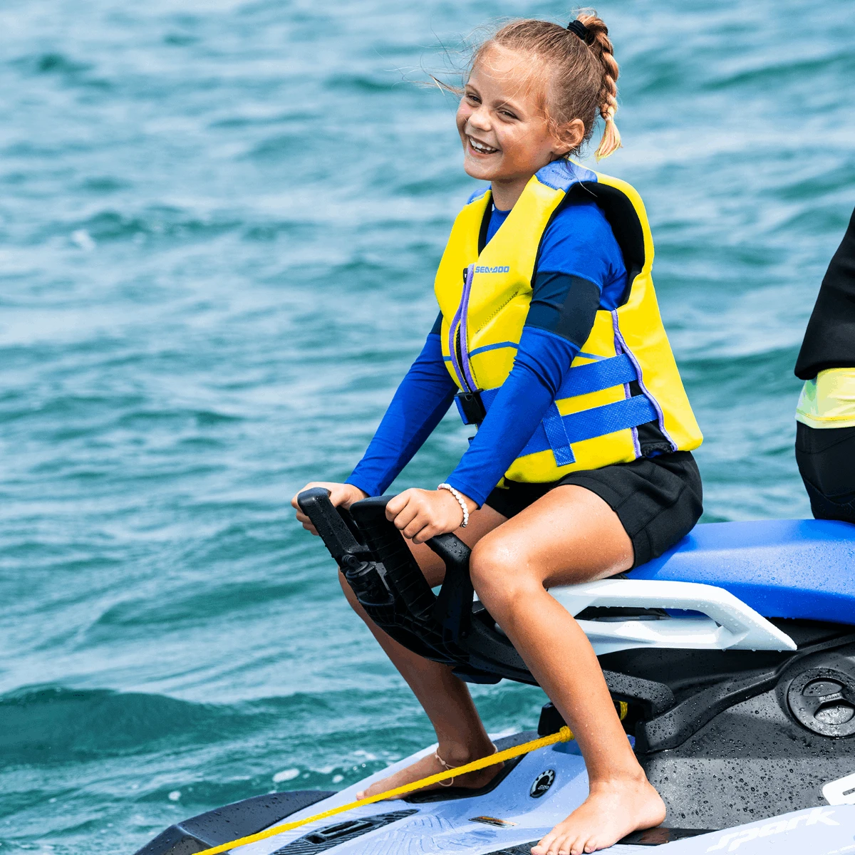 Sea-Doo Spark Spotter Handle & Camera Mount on blue watercraft; child rider wearing a yellow life vest.