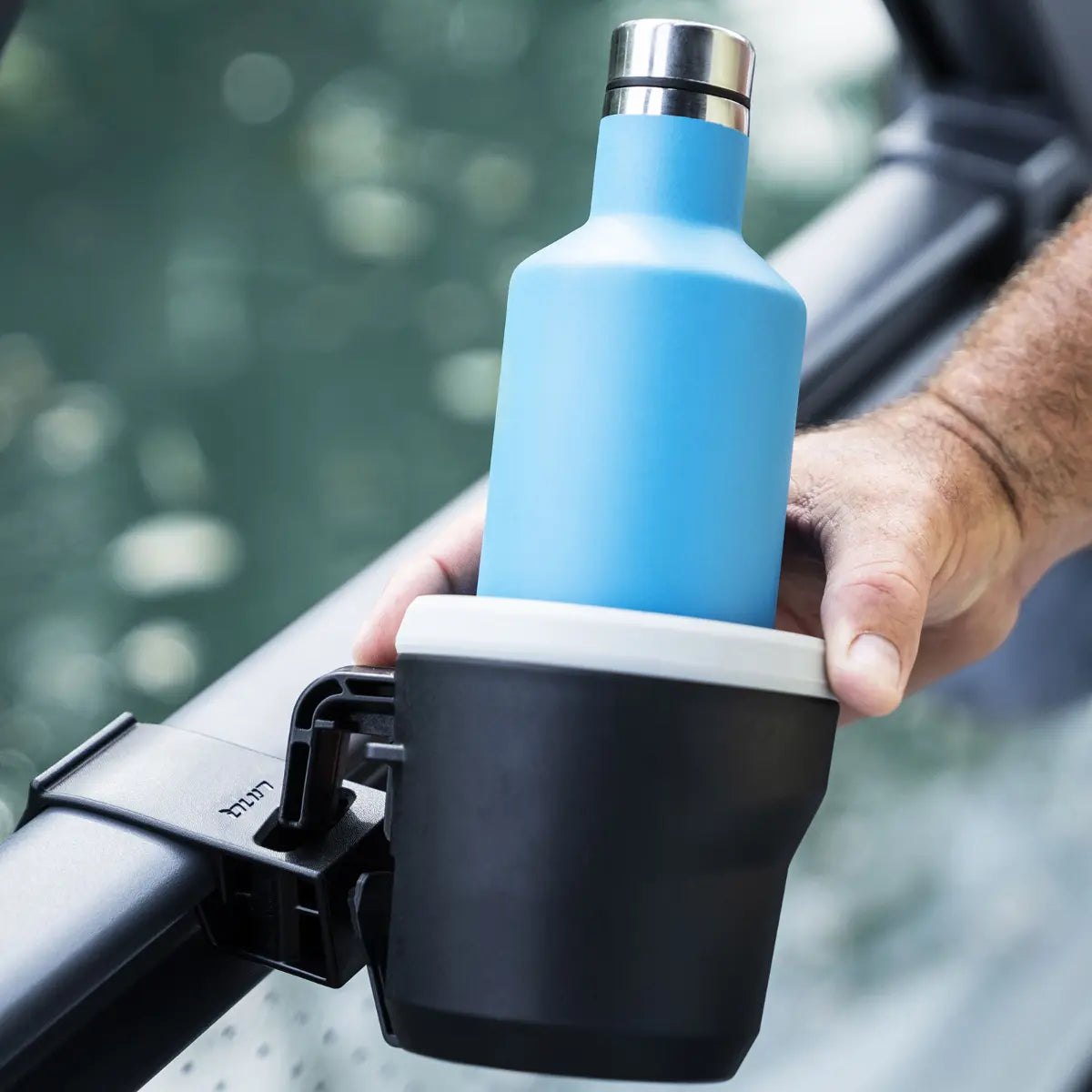 Sea-Doo LinQ Lite Rail Holder with blue bottle secured in a black cup holder on a watercraft