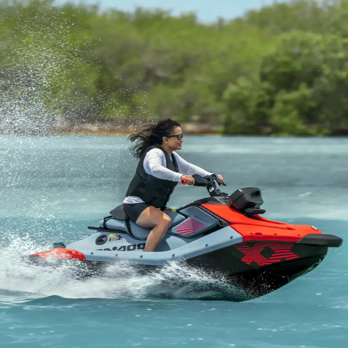 Sea-Doo Spark Performance Saddle, BRP Sea-Doo watercraft accessory on orange and gray jet ski with rider.