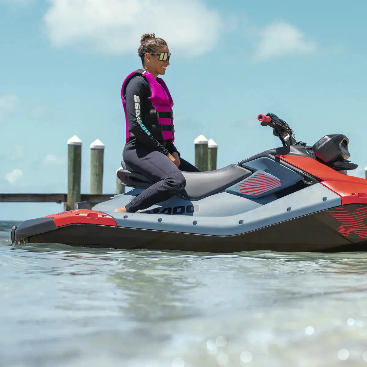 Sea-Doo Spark Trixx 2-seat jet ski by BRP Sea-Doo; rider wears pink life vest