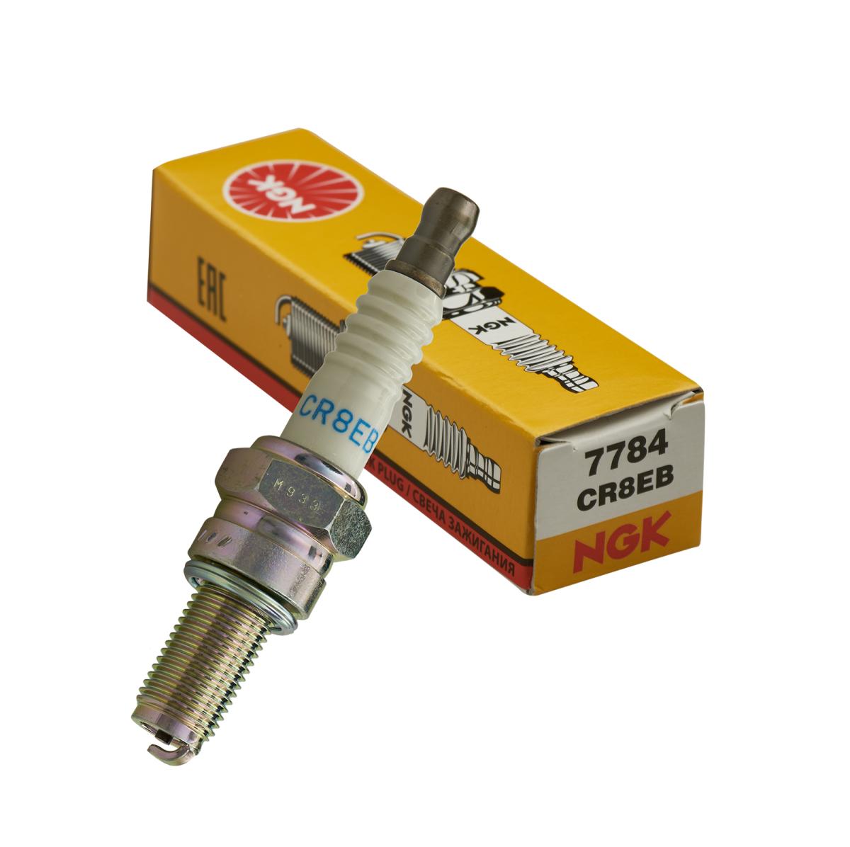 NGK spark plug CR8EB with white ceramic and metal body beside yellow NGK box for Sea-Doo watercraft ignition parts