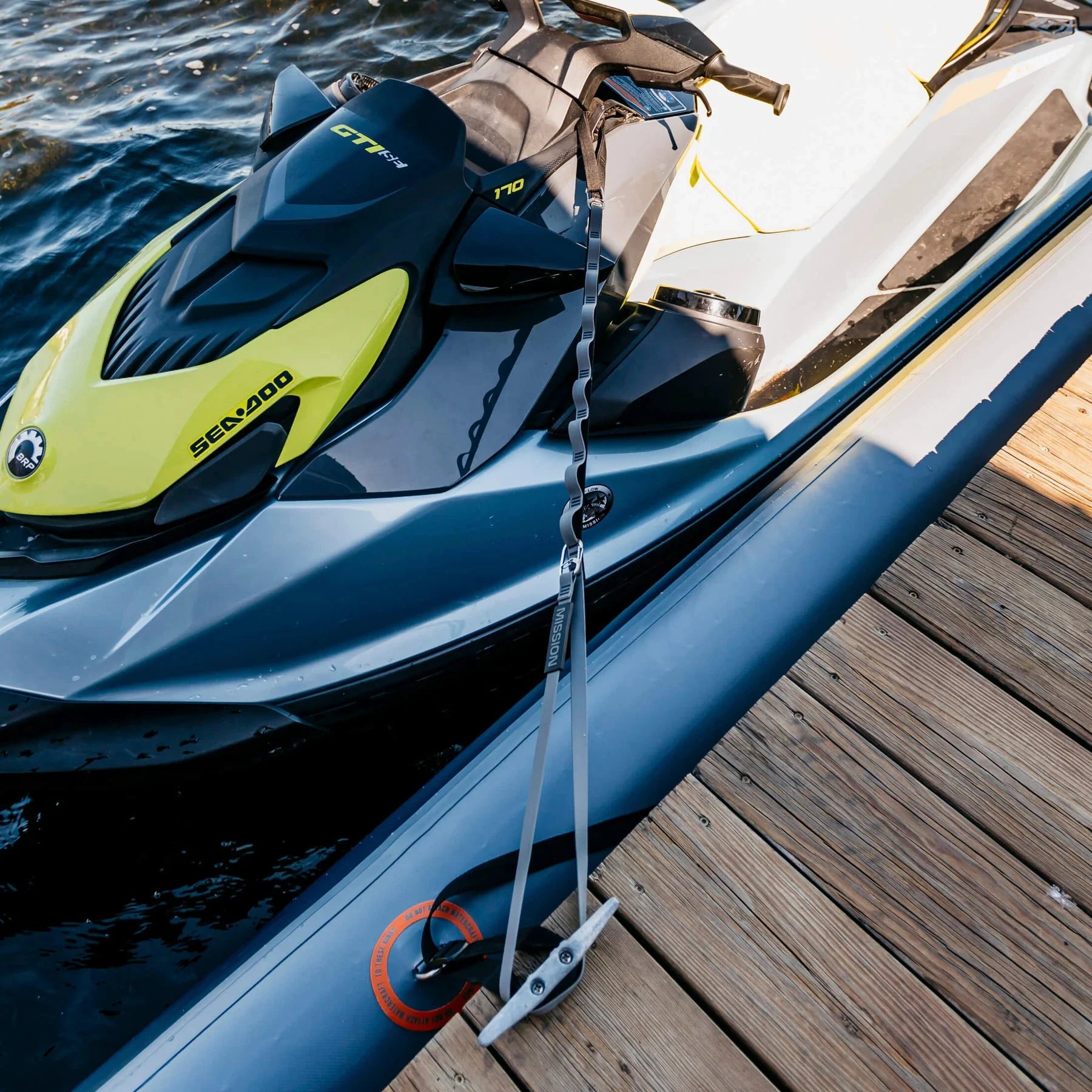 Mission PWC Tethers gray dock lines sold in pairs attached to a jet ski at a wooden dock by Mission Outdoors