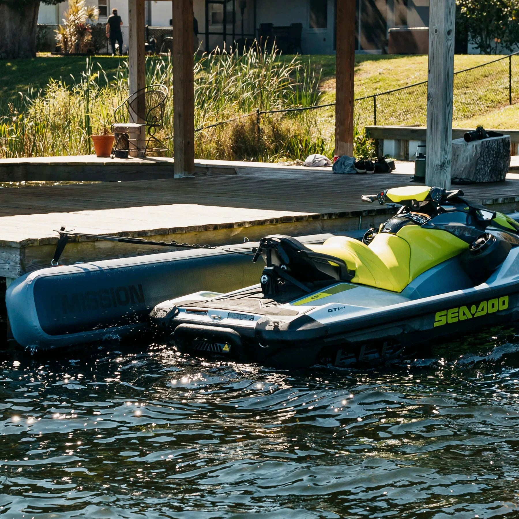 Mission Outdoors PWC tethers, sold in pairs, securing a yellow Sea-Doo jet ski to a wooden dock.