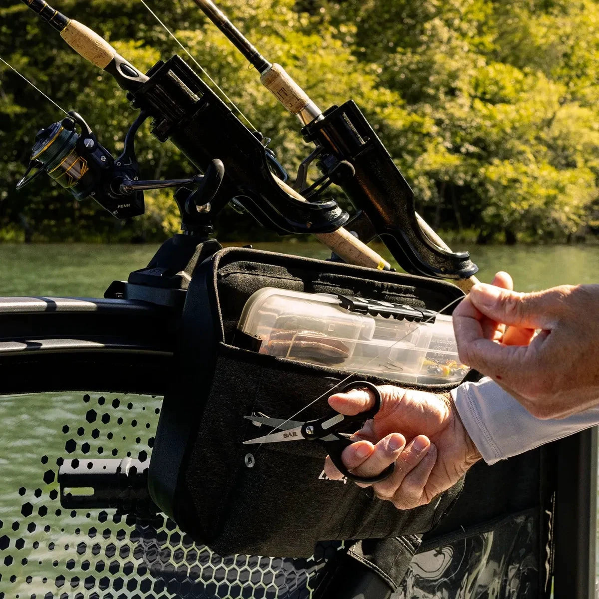 Sea-Doo LinQ Lite Multipurpose Bag in black mounted on a watercraft with fishing rods and a tackle box.