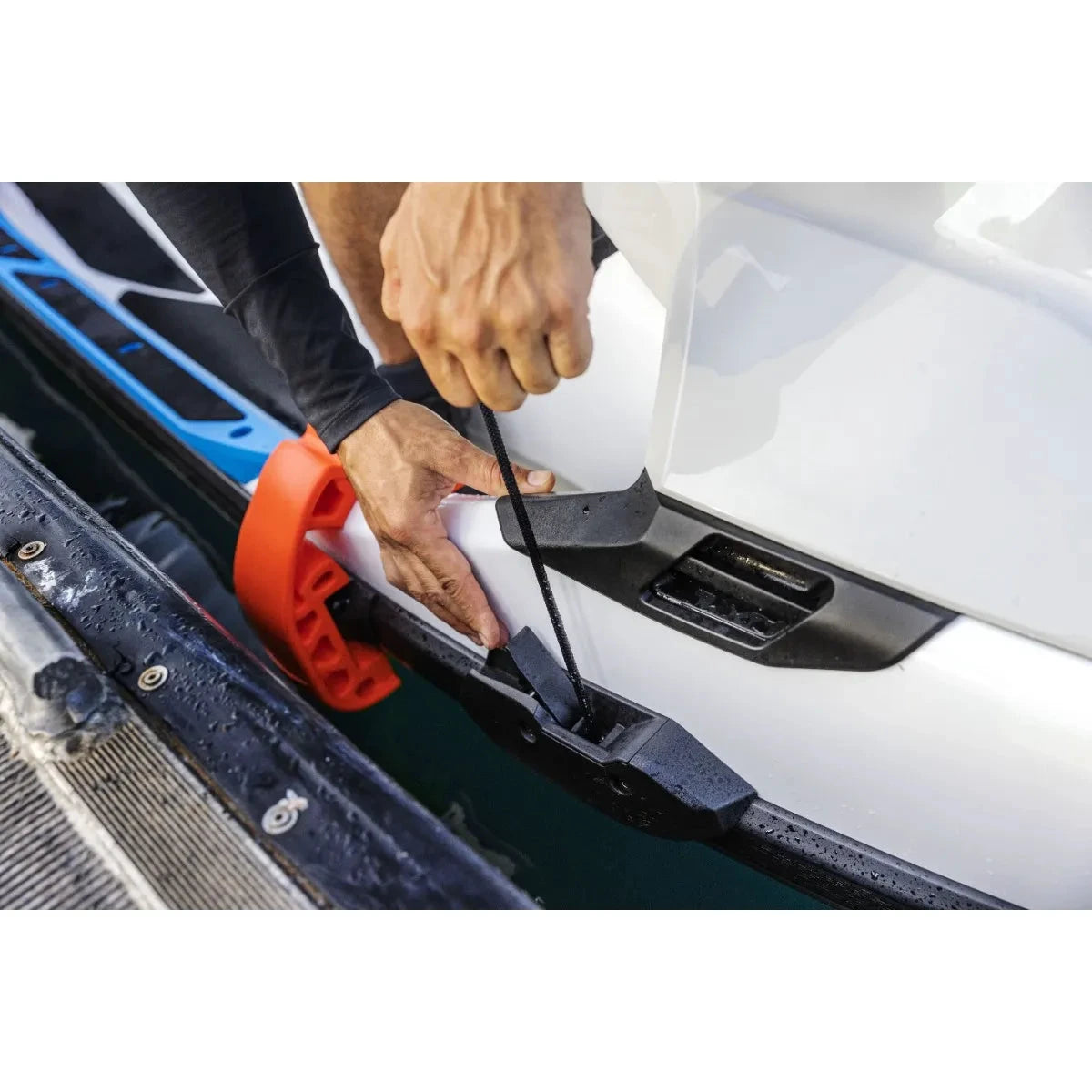 Sea-Doo Speed Tie dock cleat for Fish Pro PWC; orange ring with black cord on white hull