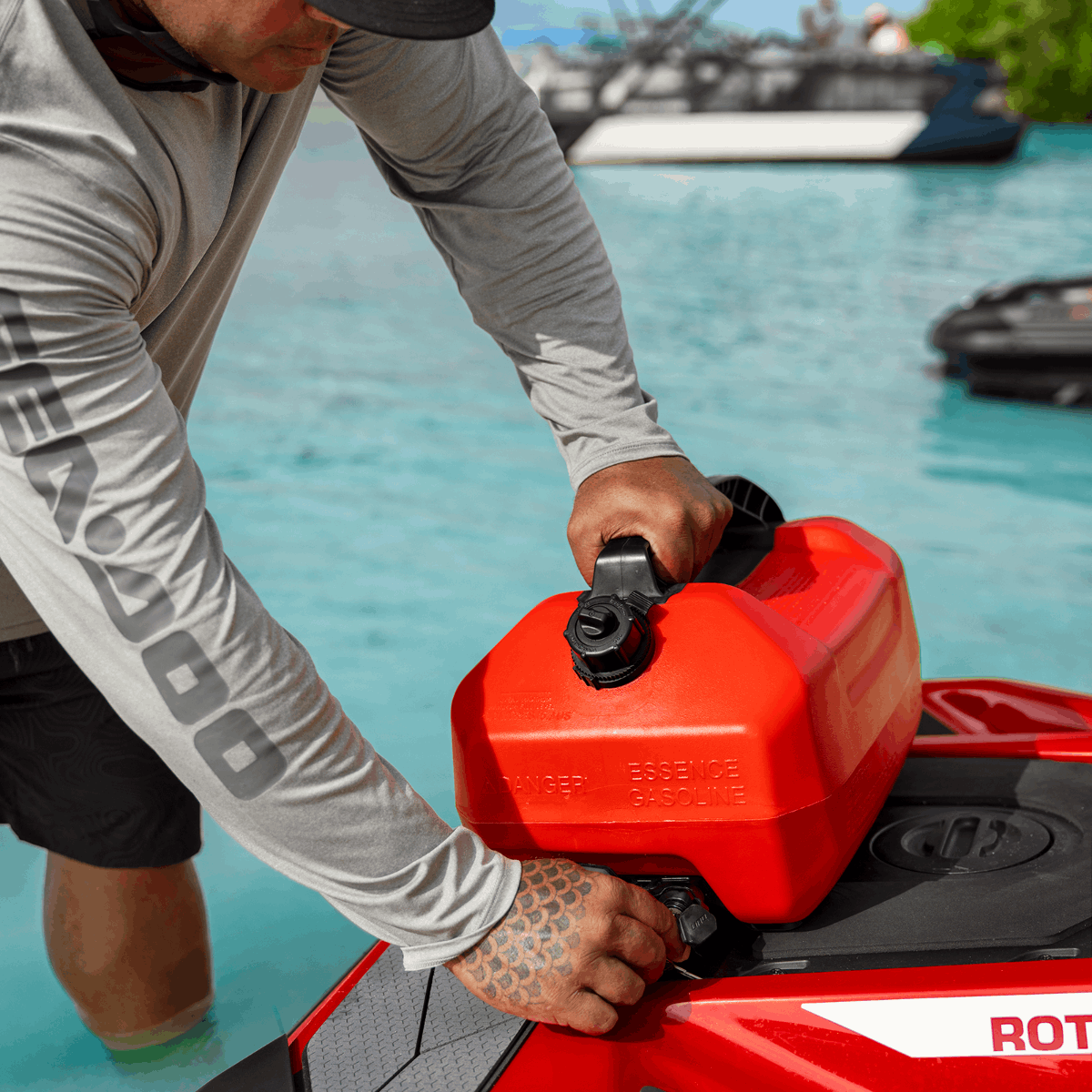 Sea-Doo LinQ 5-Gallon Fuel Caddy with black cap, mounted on a red jet ski.