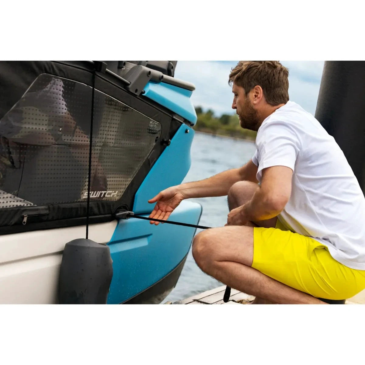 Sea-Doo Switch Speed Tie docking accessory on a blue Sea-Doo watercraft; man secures the line