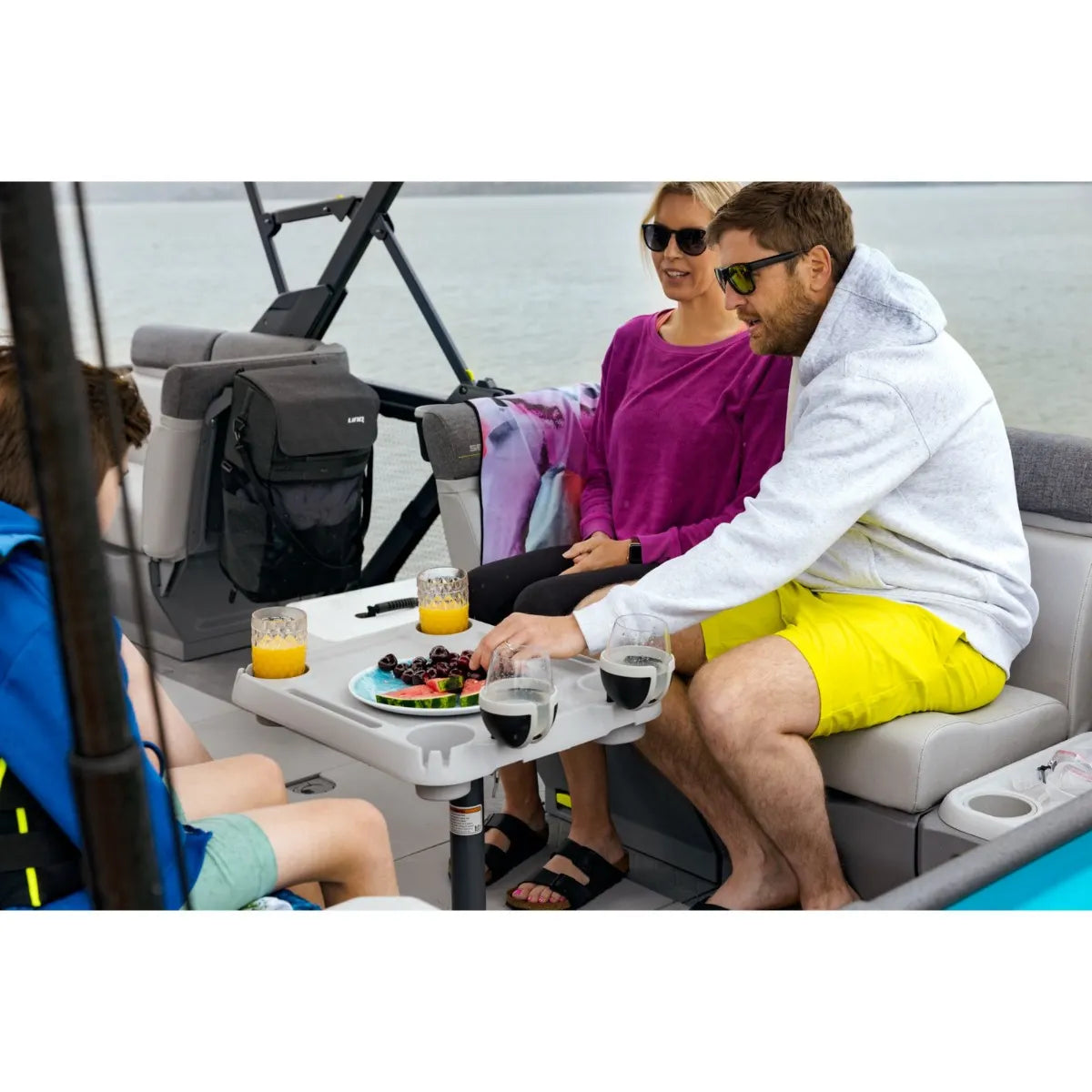 Sea-Doo Switch Adjustable Table on a watercraft, gray portable table with built-in cup holders.