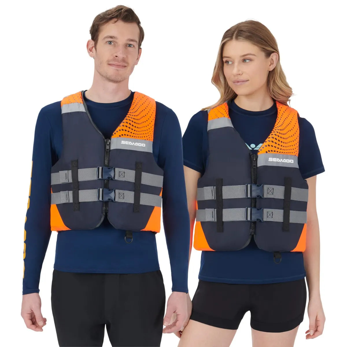 Sea-Doo Motion life jackets in orange and navy with grey straps on two people wearing navy shirts
